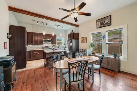 a view of a dining room with furniture window and wooden floor