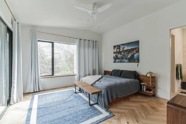 a bedroom with a bed and a window