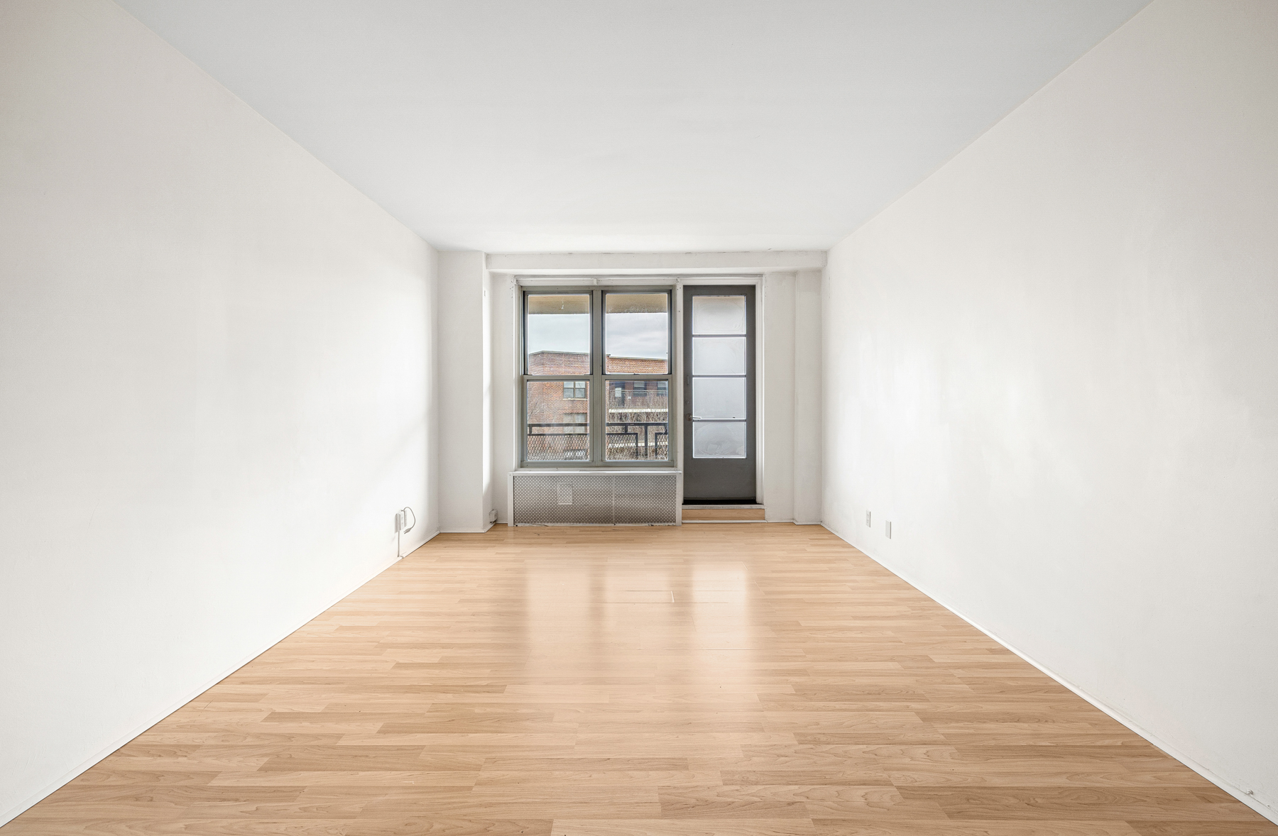 35-50 85th Street, Unit 9J Queens, NY 11372 - Photo 2 of 16 a view of an empty room with a window