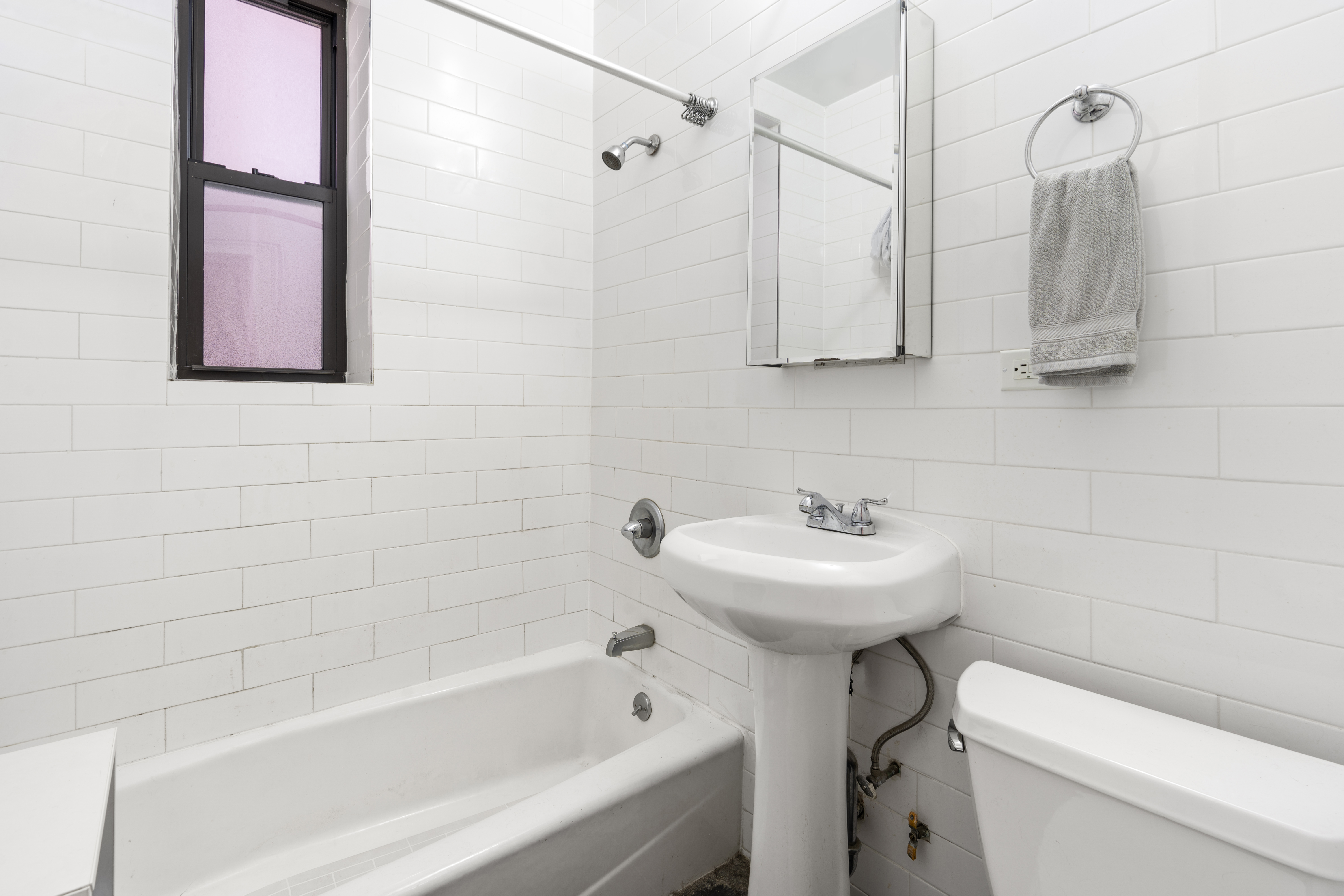 660 Riverside Drive, Unit 2A Manhattan, NY 10031 - Photo 5 of 6 a bathroom with a sink a toilet and shower