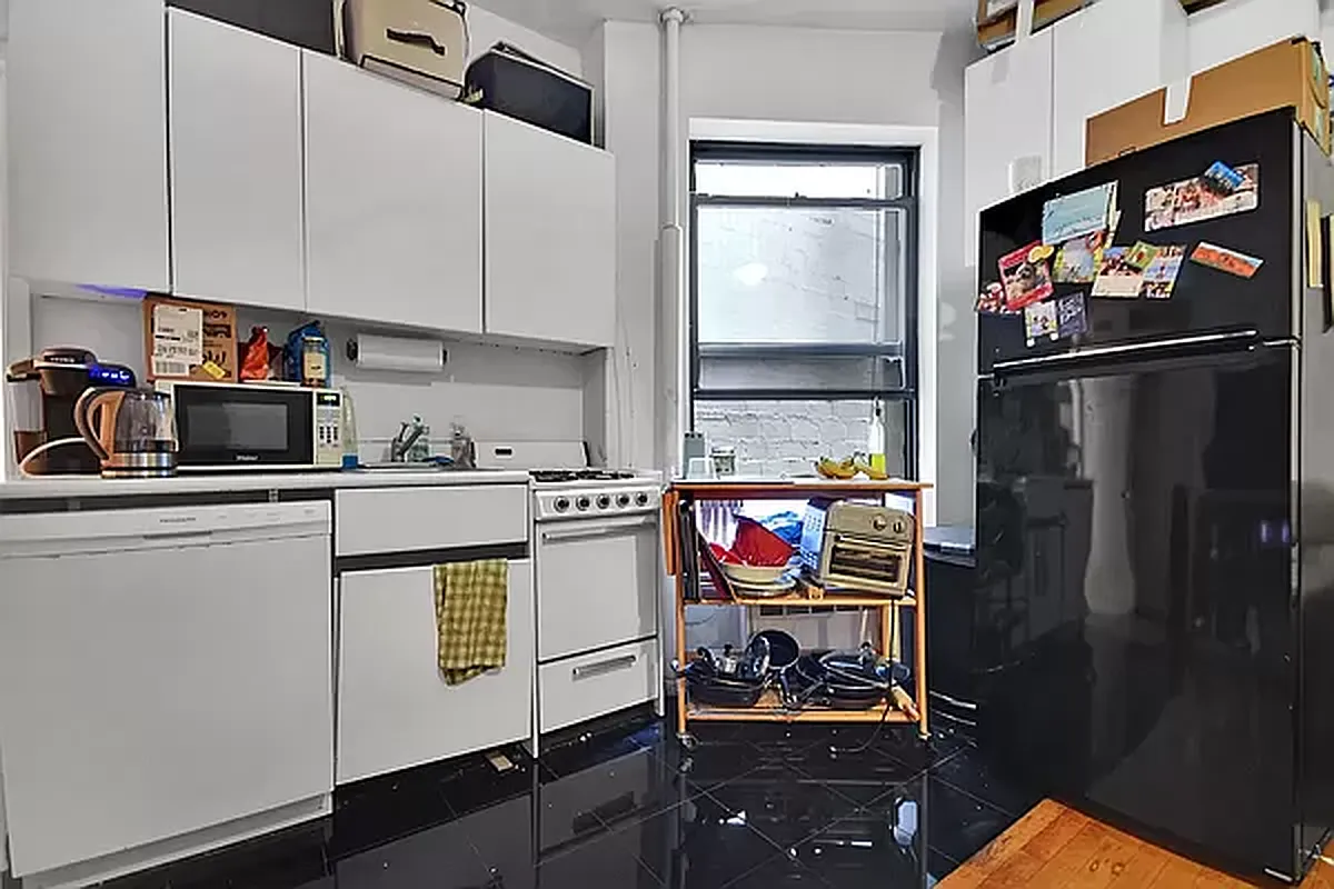 416 East 71st Street, Unit 17 Manhattan, NY 10021 - Photo 5 of 8 a kitchen with stainless steel appliances a refrigerator and a stove top oven