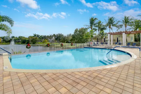 a swimming pool with outdoor seating and yard