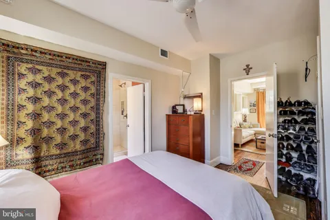 a bedroom with a bed and a mirror