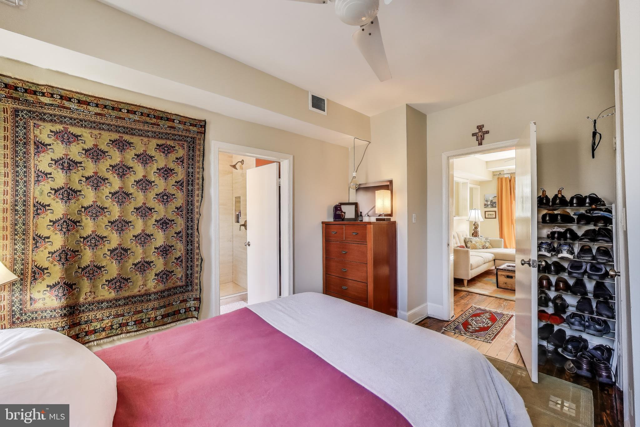 1317 Corcoran Street Northwest Washington, DC 20009 - Photo 15 of 47 a bedroom with a bed and a mirror