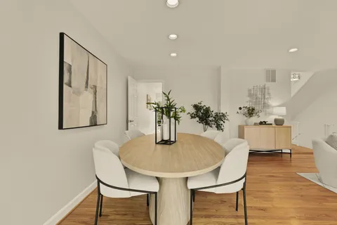 a living room with furniture potted plant and a large window