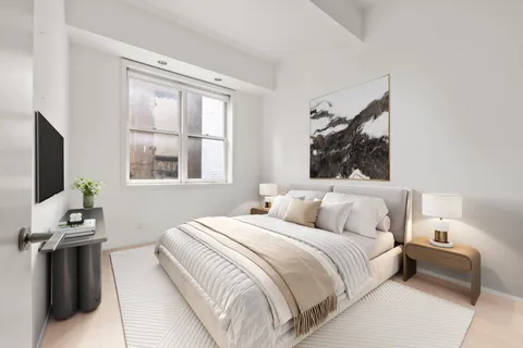 a bedroom with a bed and a flat tv screen