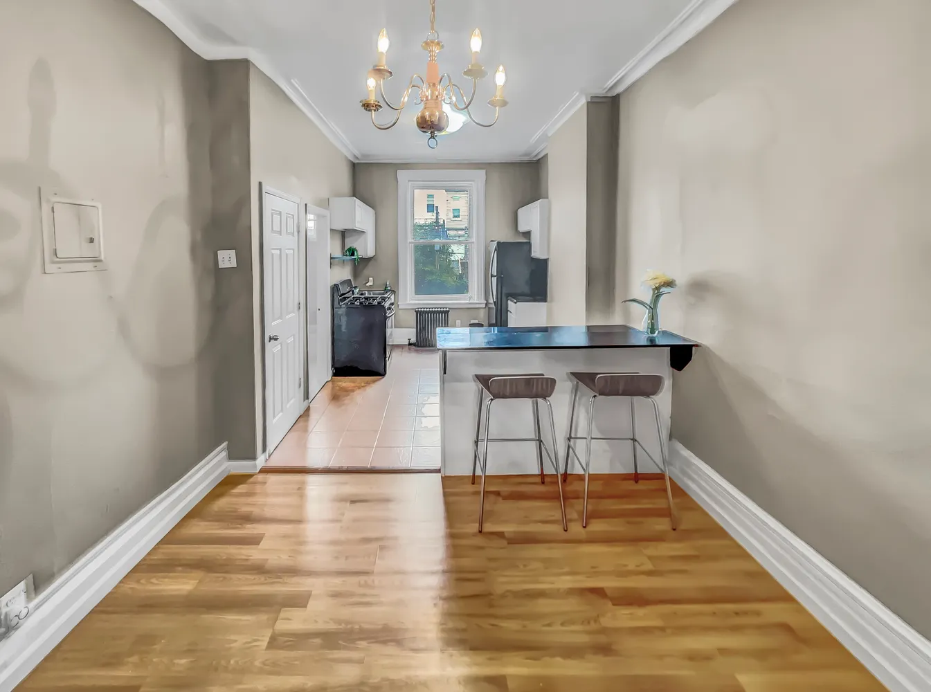 a view of a room with kitchen island stainless steel appliances with wooden floor