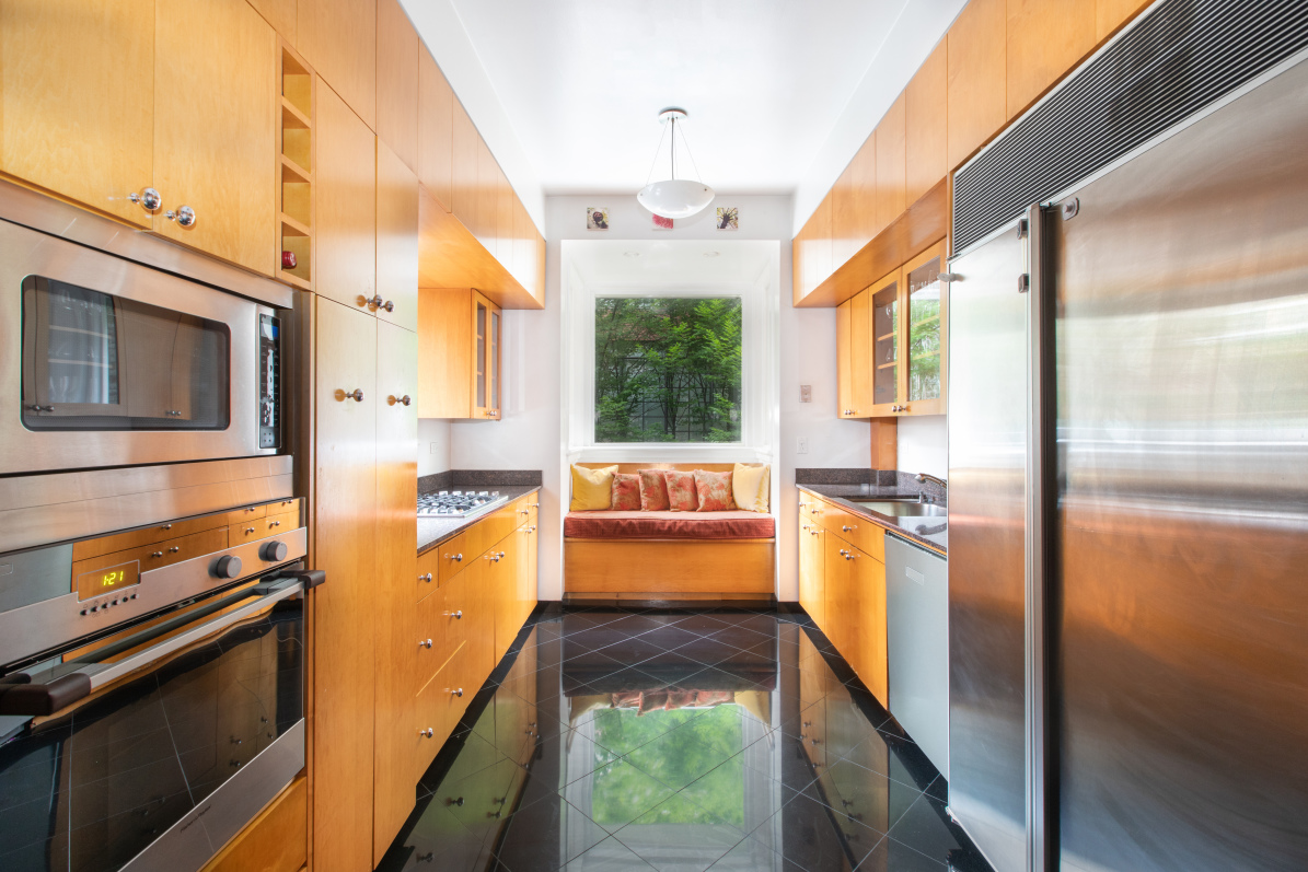27 West 87th Street, Unit 1 Manhattan, NY 10024 - Photo 5 of 12 a kitchen with stainless steel appliances granite countertop a refrigerator a stove and a microwave