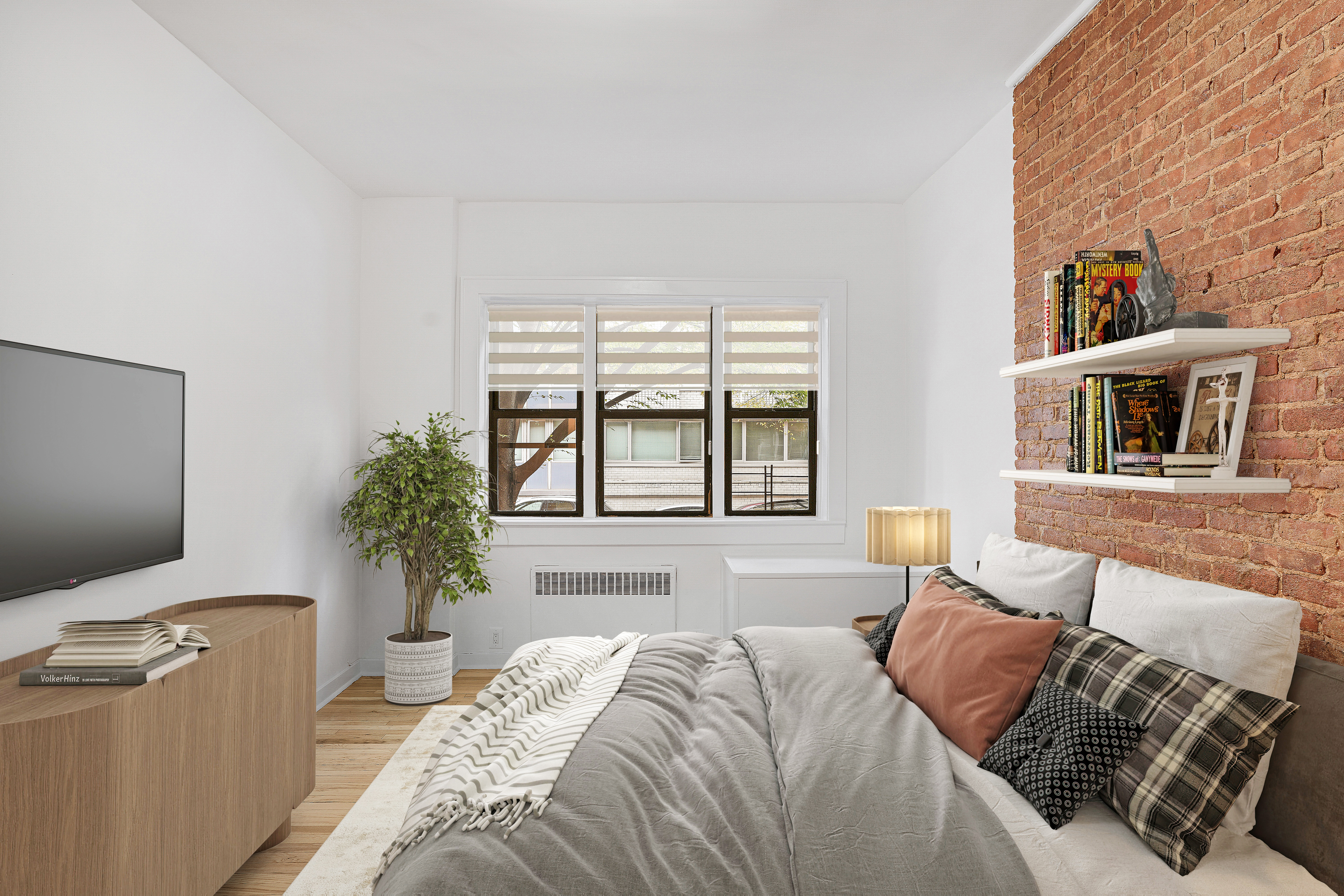 433 East 82nd Street, Unit 1A Manhattan, NY 10028 - Photo 3 of 6 a bedroom with a bed and a couch