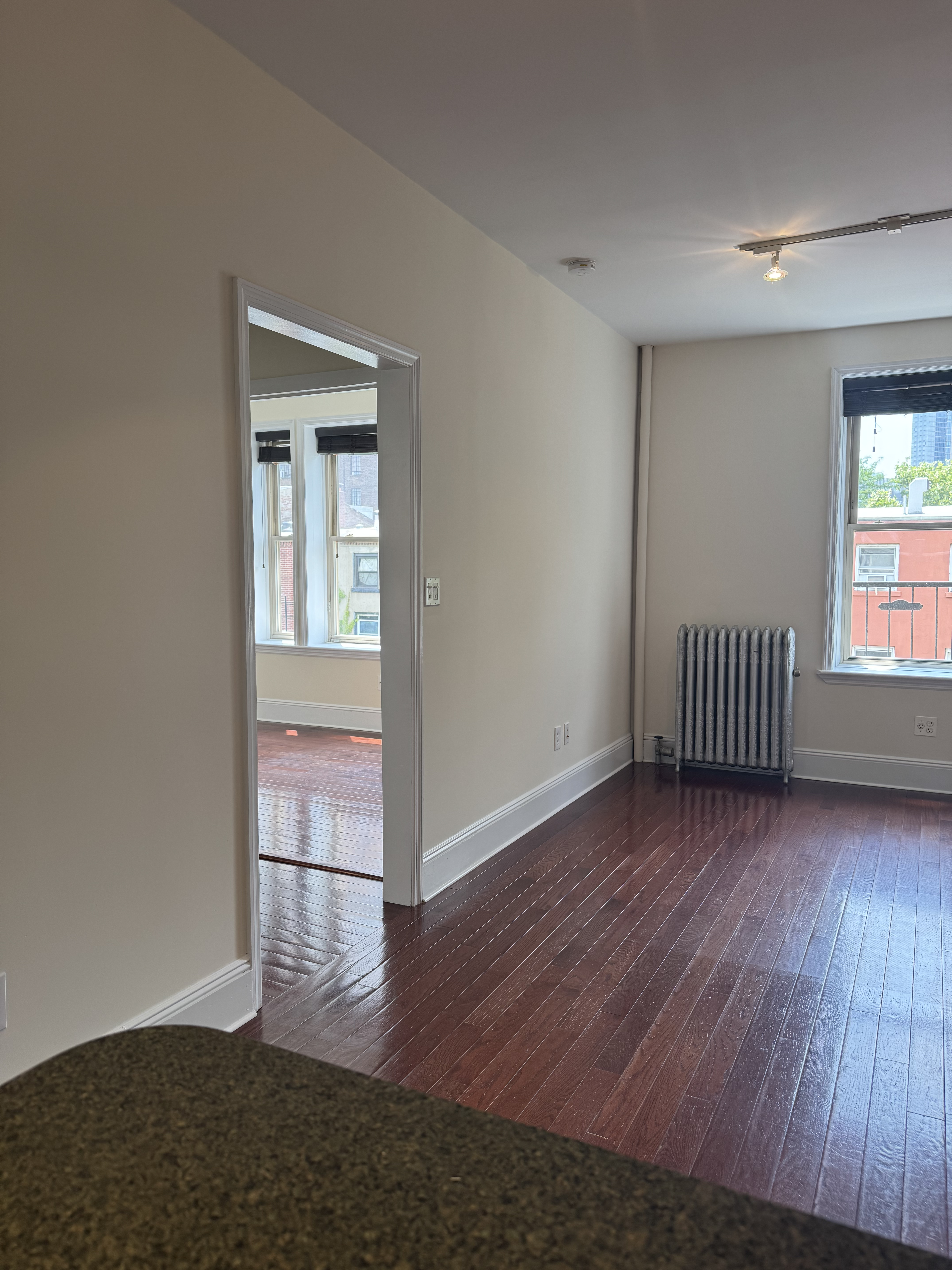260 Cumberland Street, Unit 15 Brooklyn, NY 11205 - Photo 2 of 10 an empty room with wooden floor and windows