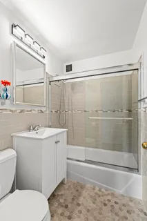 a bathroom with a sink mirror toilet and bathtub