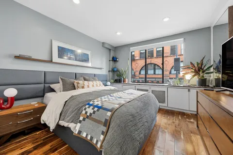 a bed room with a bed and a large window