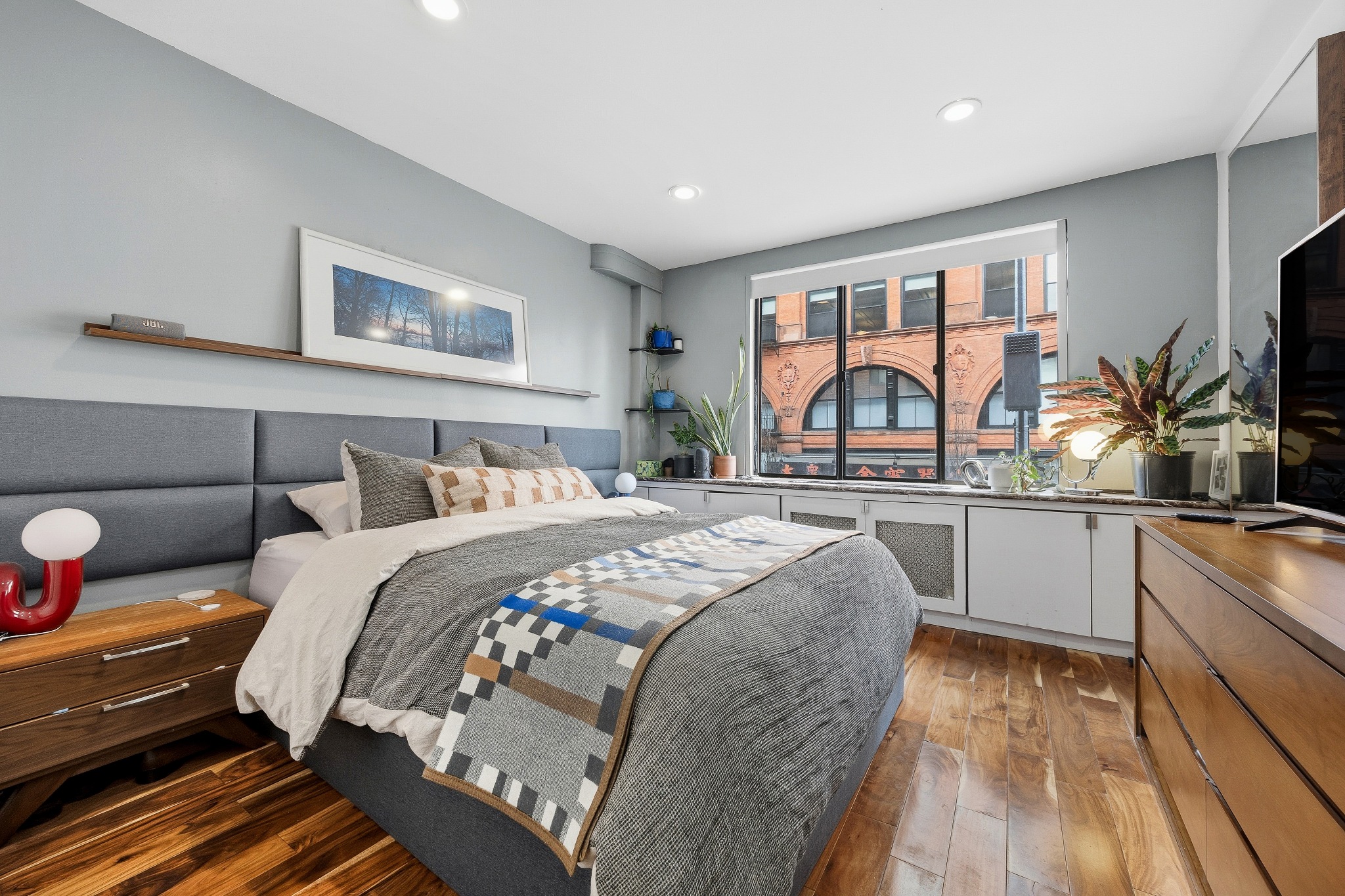 179 Grand Street, Unit 2F Manhattan, NY 10013 - Photo 6 of 11 a bed room with a bed and a large window