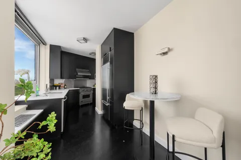 a view of kitchen with furniture and wooden floor