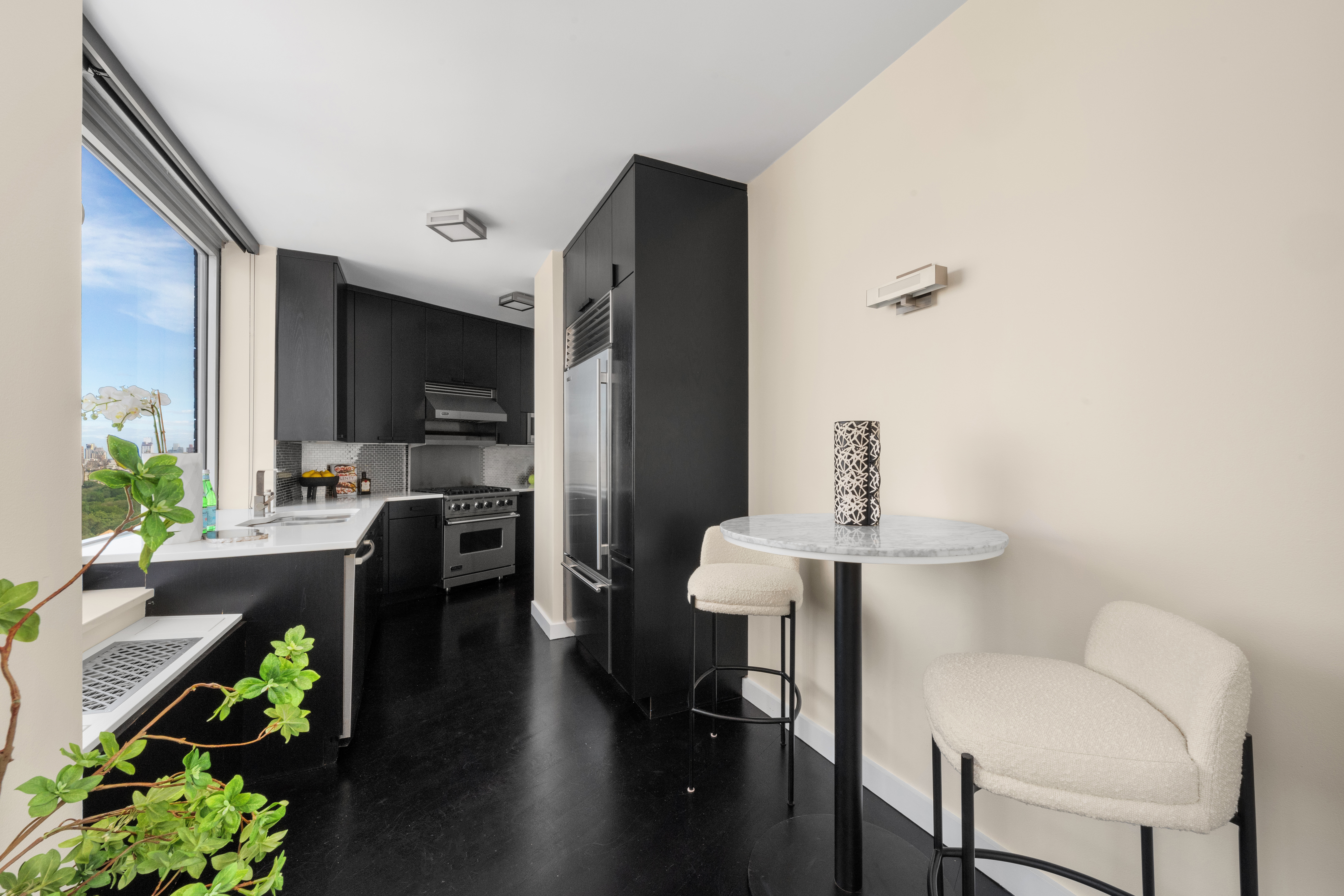 150 Columbus Avenue, Unit 22A Manhattan, NY 10023 - Photo 6 of 23 a view of kitchen with furniture and wooden floor