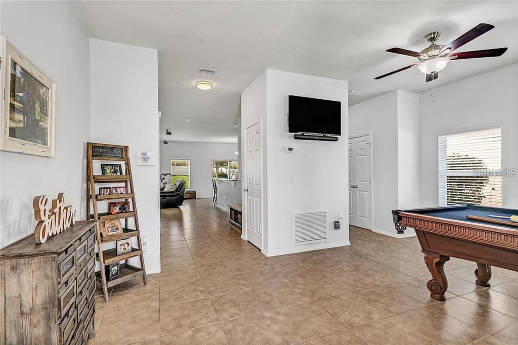 352 Giovani Boulevard Clermont, FL 34715 - Photo 5 of 46 a living room with furniture and a flat screen tv