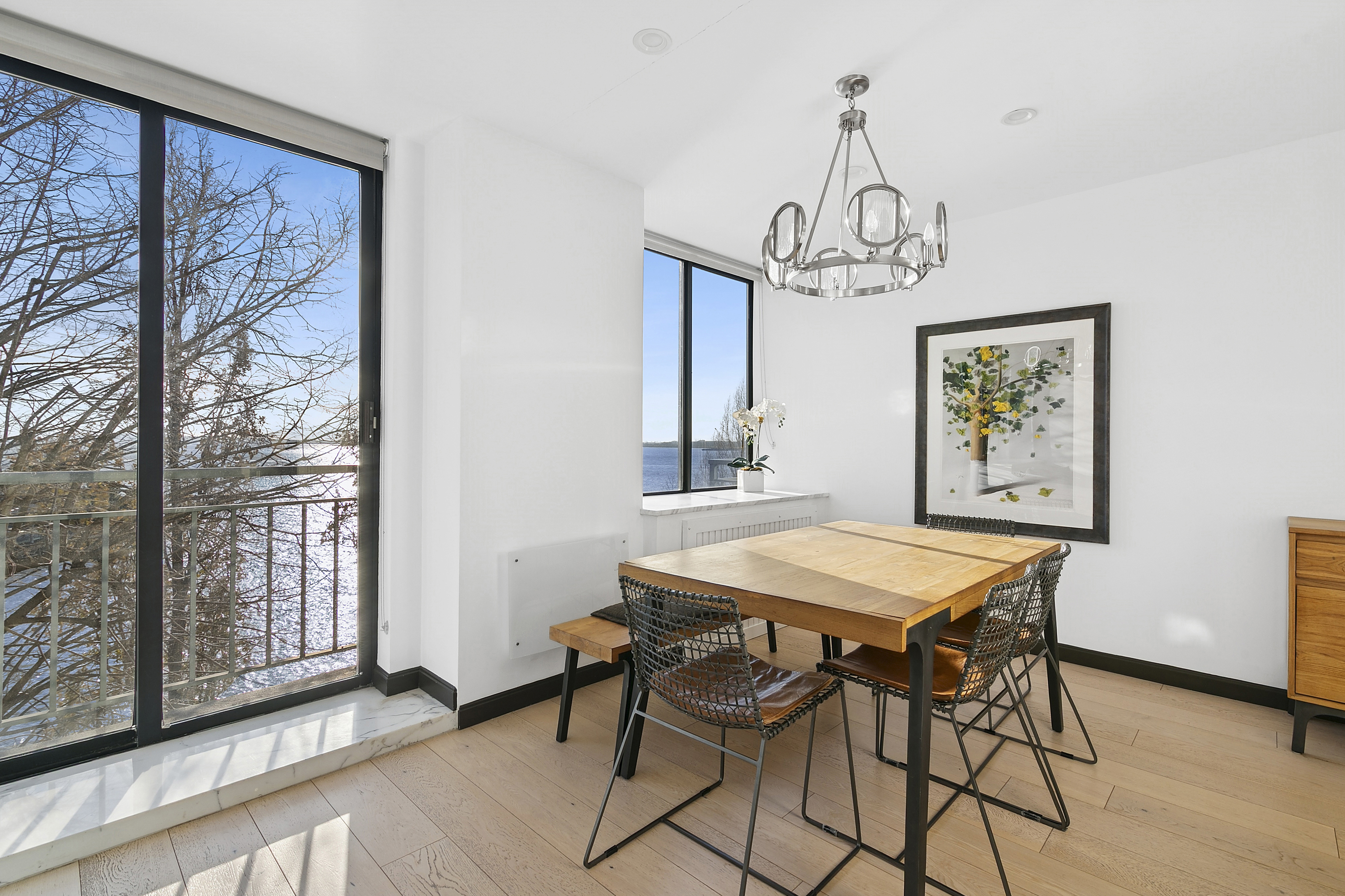 21 South End Avenue, Unit 402 Manhattan, NY 10280 - Photo 4 of 13 a view of a dining room with furniture window and wooden floor