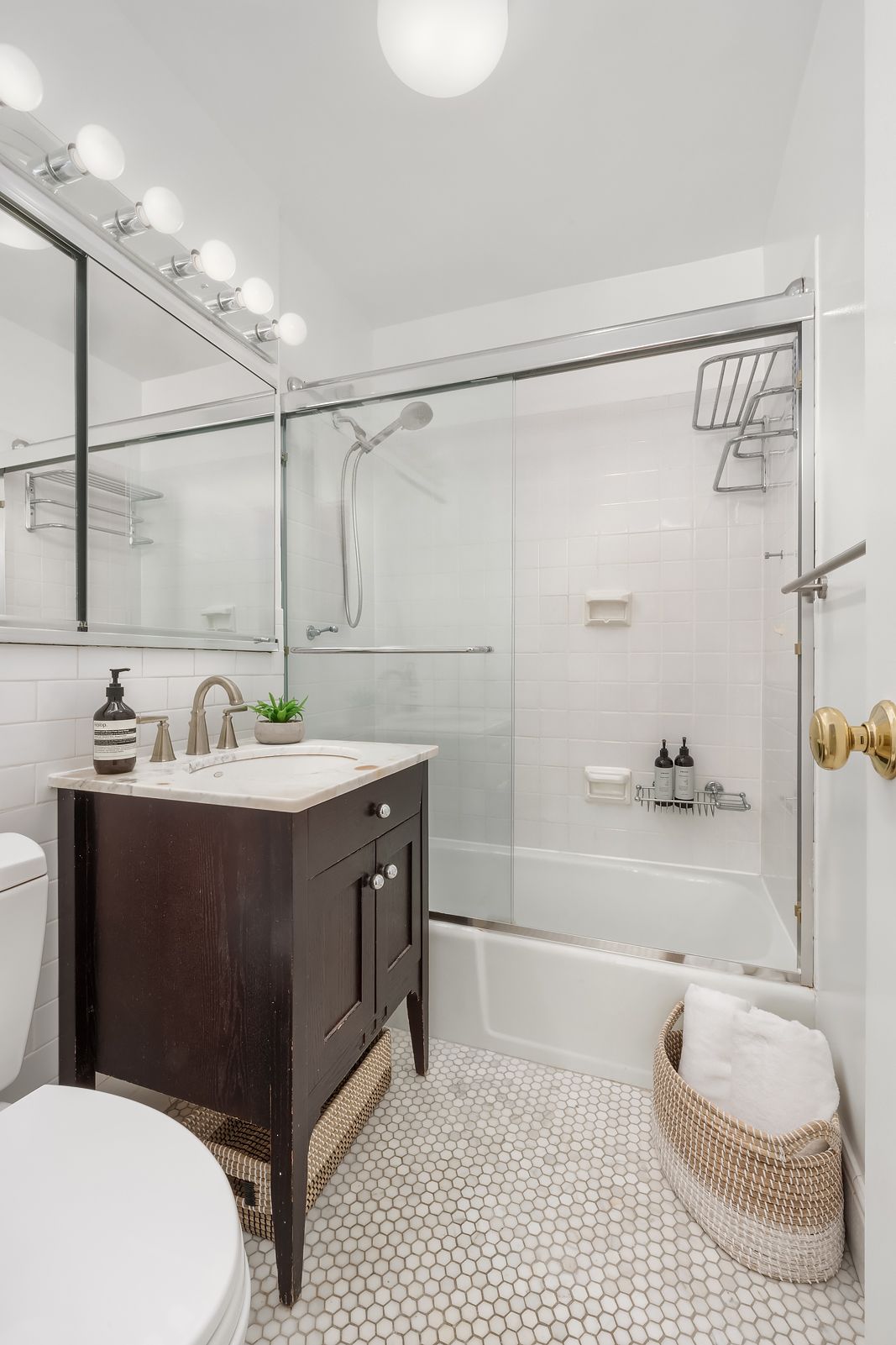 178 East 80th Street, Unit 7F Manhattan, NY 10075 - Photo 8 of 10 a bathroom with a sink a toilet and shower