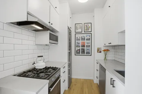 a kitchen with stainless steel appliances a stove and a refrigerator