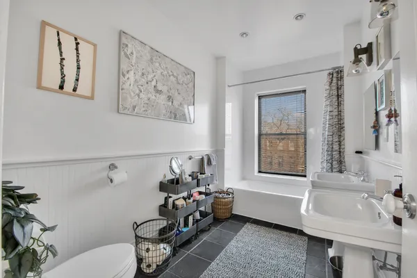 a bathroom with a bathtub sink and toilet