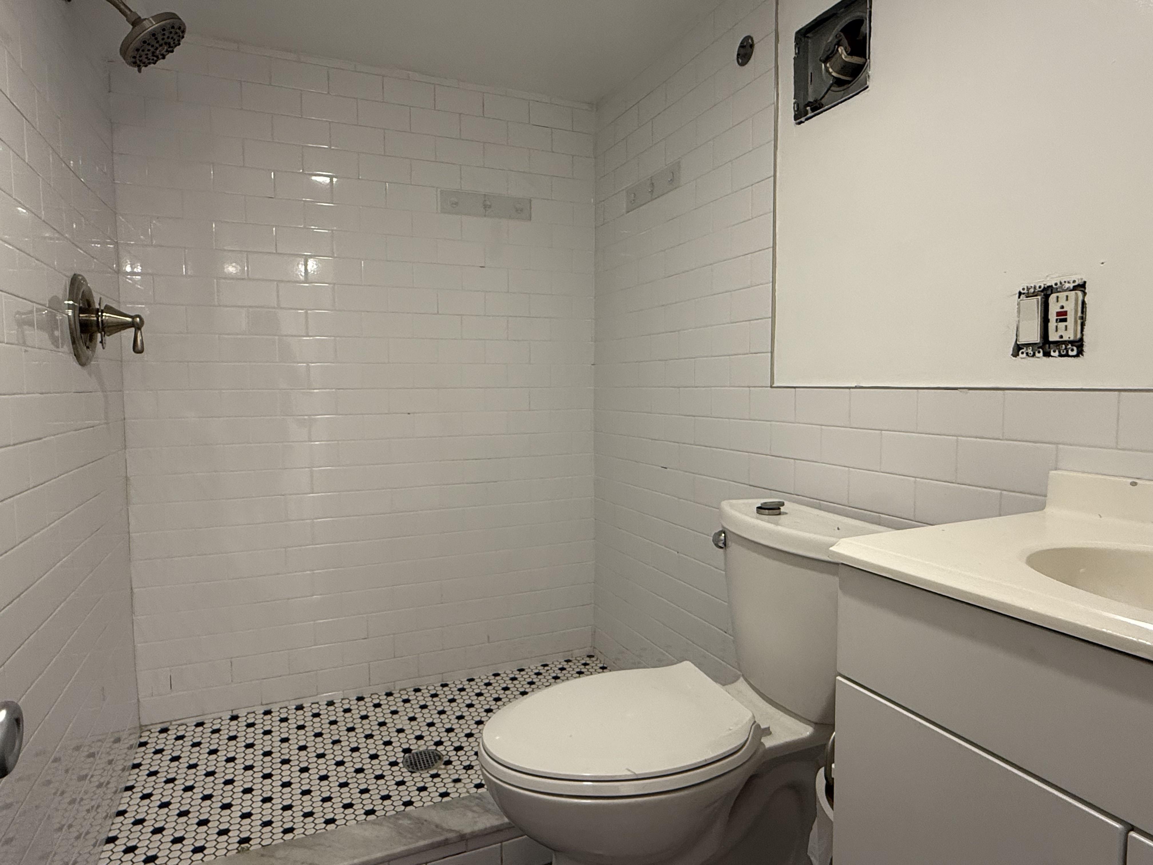 249 94th Street, Unit 1 Brooklyn, NY 11209 - Photo 10 of 13 a bathroom with a sink toilet and vanity
