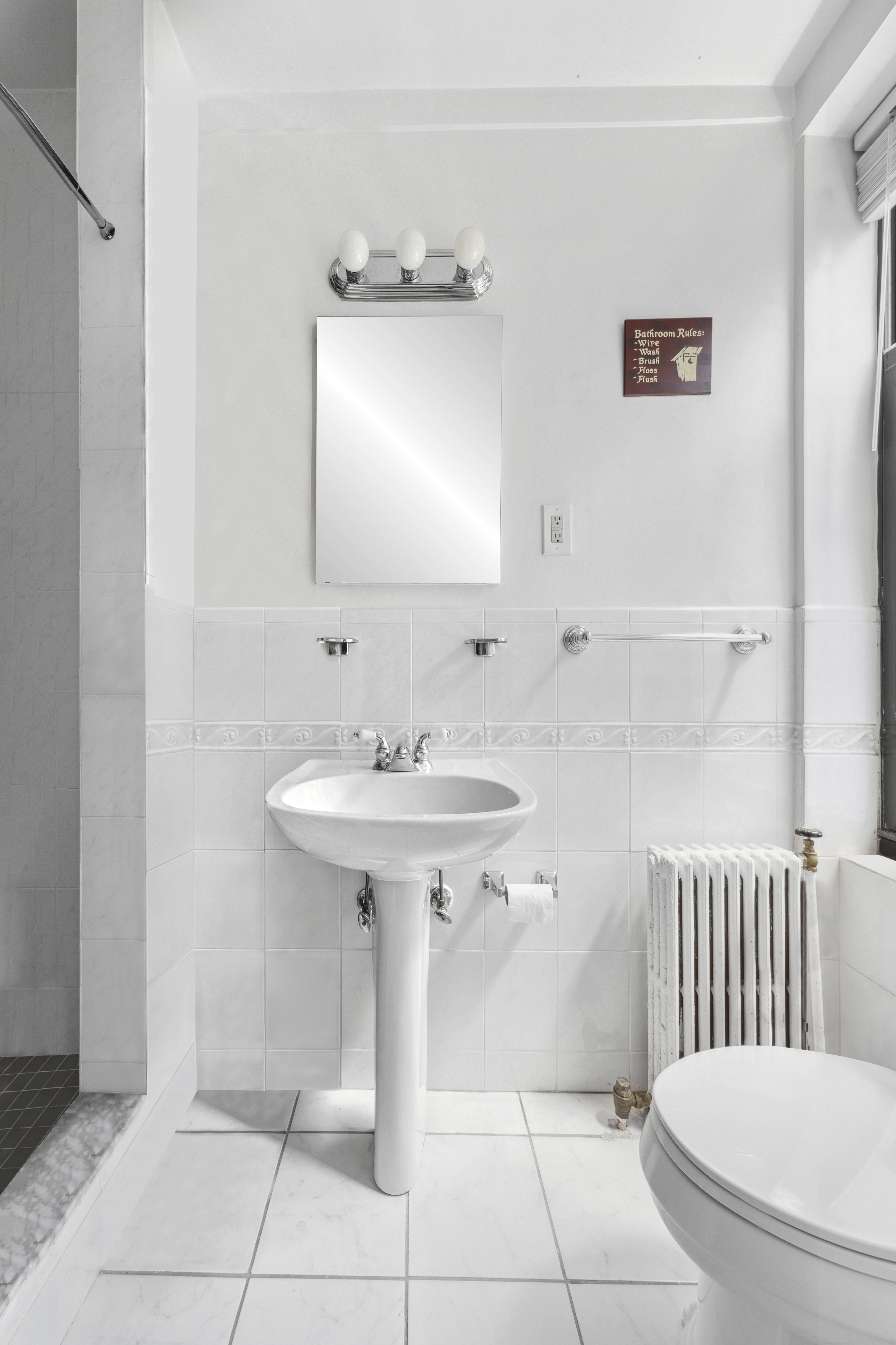 200 West 86th Street, Unit 7C Manhattan, NY 10024 - Photo 12 of 14 a bathroom with a sink toilet and mirror
