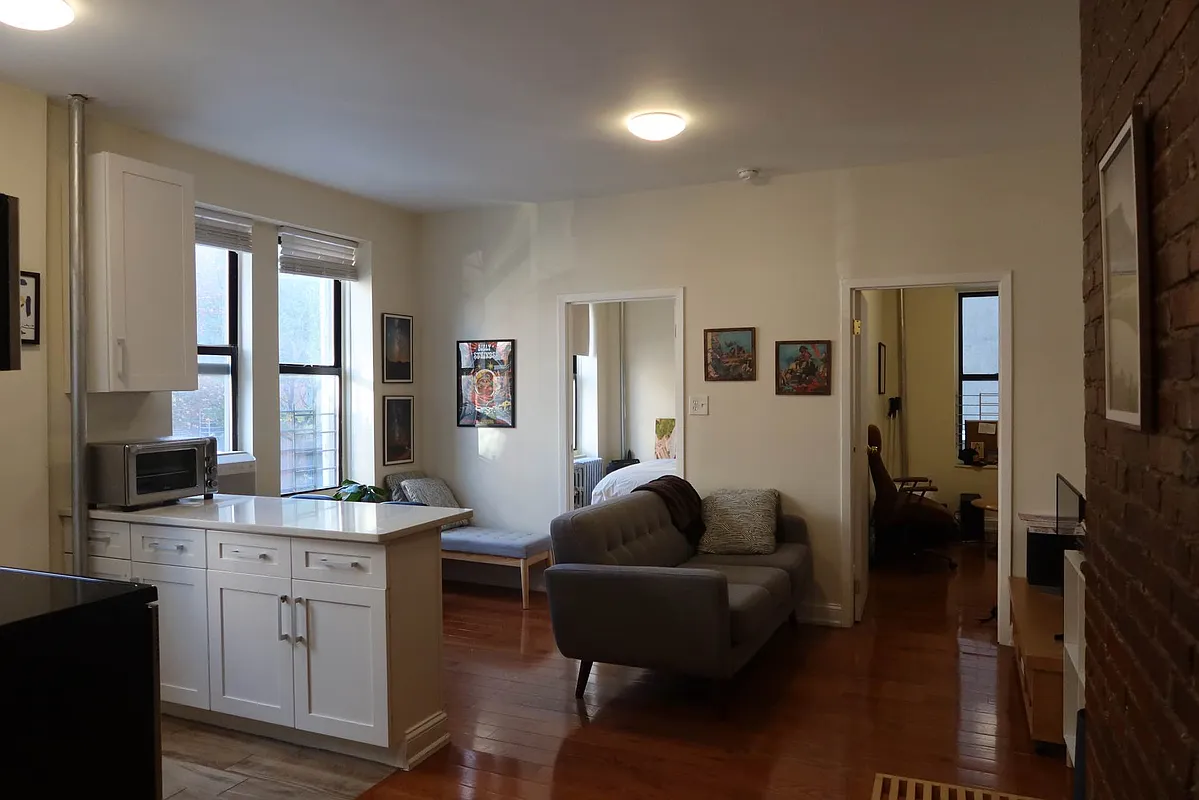 a living room with furniture window and wooden floor