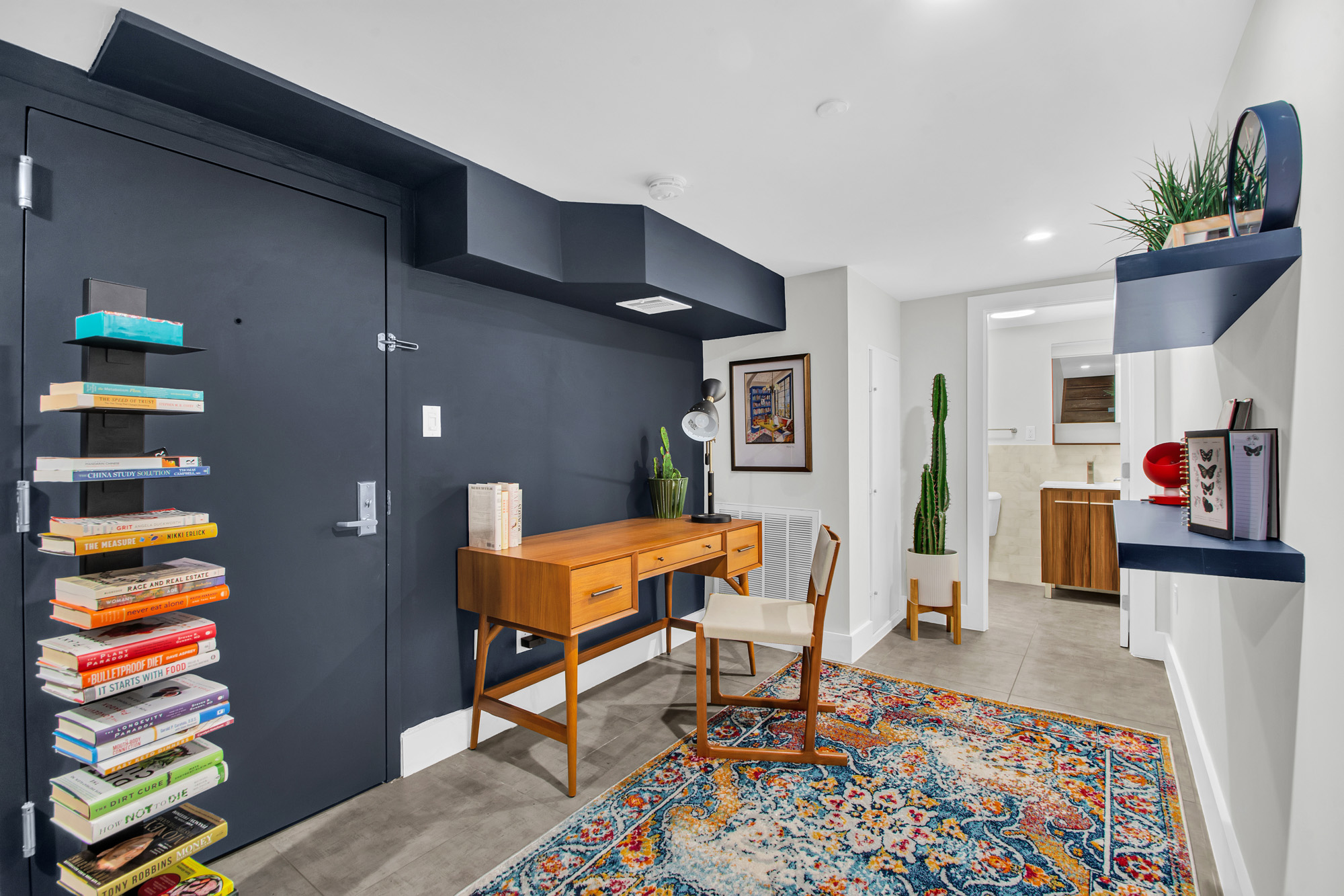 159 West 126th Street, Unit GARDEN A Manhattan, NY 10027 - Photo 9 of 15 a living room with furniture and a book shelf