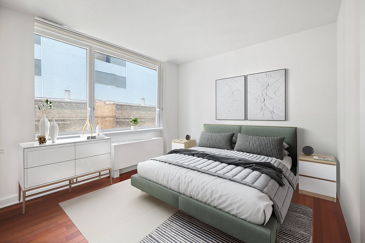 100 Riverside Boulevard, Unit 6C Manhattan, NY 10069 - Photo 3 of 6 a bedroom with a large bed and a large window