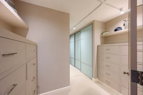 a view of walk in closet with cabinet