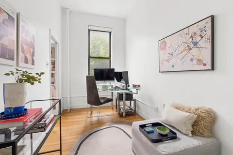 a living room with furniture and flat screen tv
