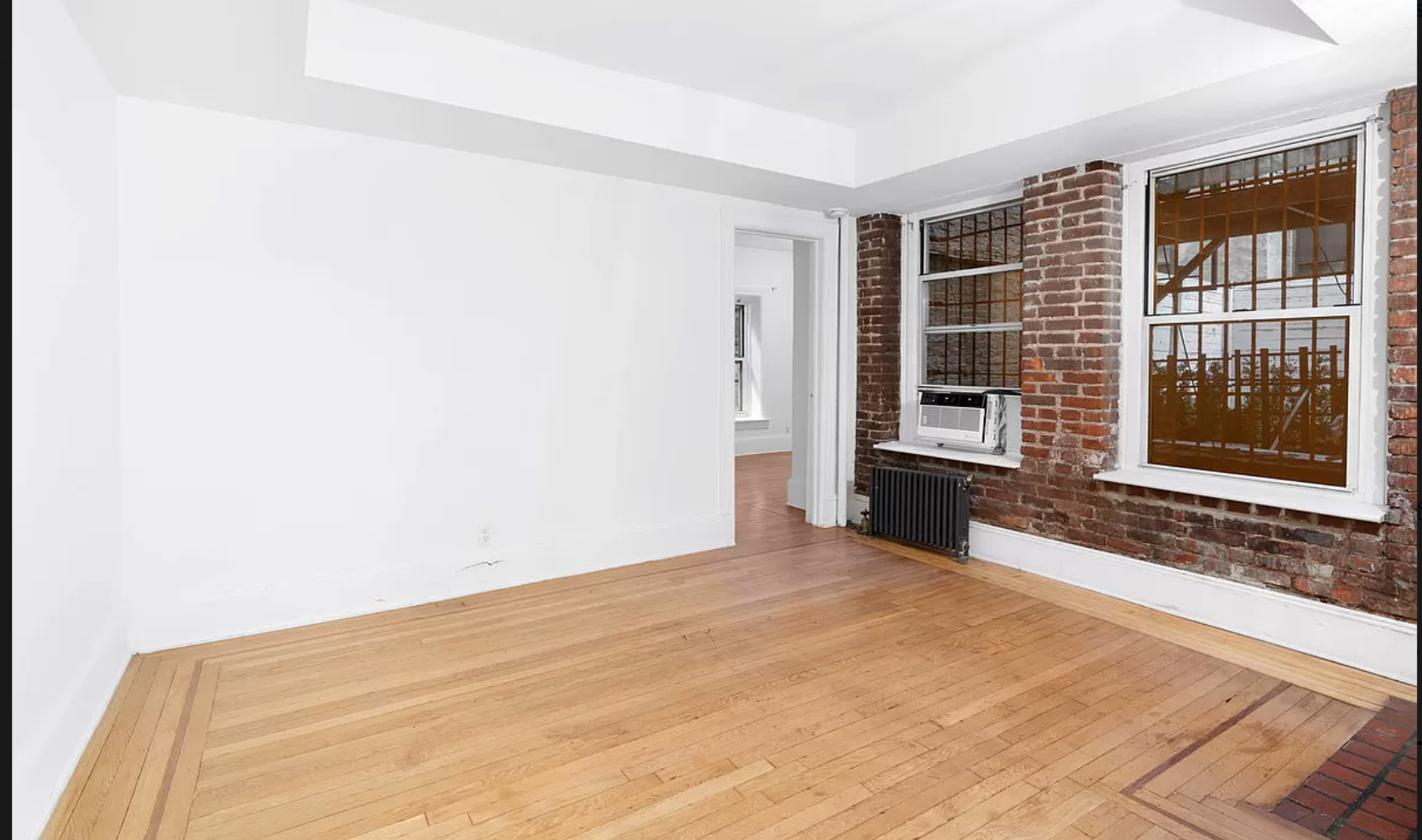 104 Bedford Street, Unit 1C Manhattan, NY 10014 - Photo 3 of 12 a view of an empty room with a window