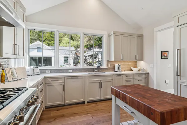 a kitchen with a stove and a white cabinets