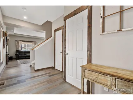 a view of hallway with wooden floor and stairs