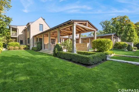 a front view of a house with garden and plants