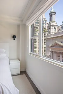 a living room with furniture a window and a ceiling fan
