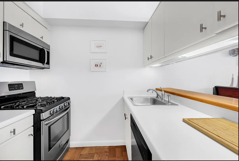 415 East 37th Street, Unit 22B Manhattan, NY 10016 - Photo 2 of 6 a kitchen that has a microwave and a stove