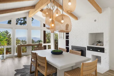 a kitchen with stainless steel appliances a dining table chairs and couches