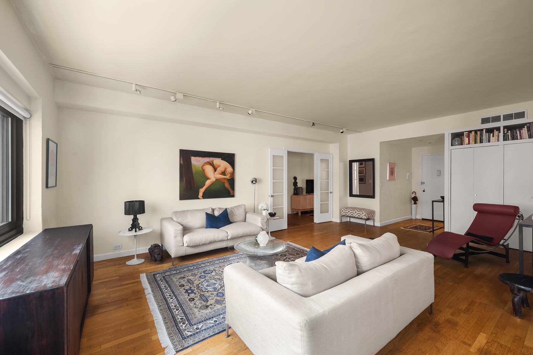 25 East 83rd Street, Unit 9B Manhattan, NY 10028 - Photo 2 of 8 a living room with furniture and wooden floor