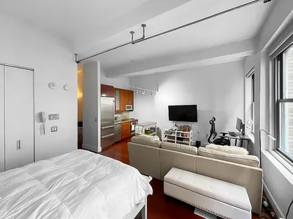 a bedroom with a bed and a flat screen tv