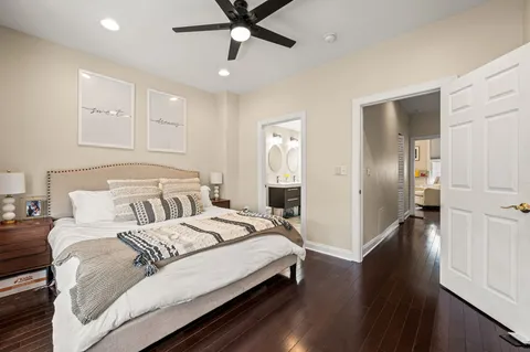 a bedroom with a bed and wooden floor