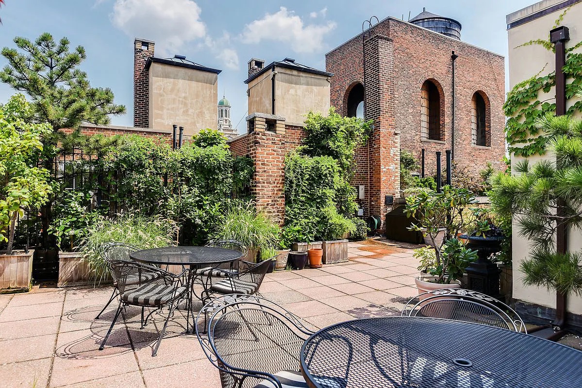 30 5th Avenue, Unit 6H Manhattan, NY 10011 - Photo 15 of 17 a patio with a table and chairs and potted plants