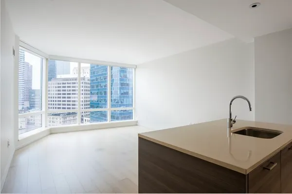 a kitchen with a sink a counter top and a stove