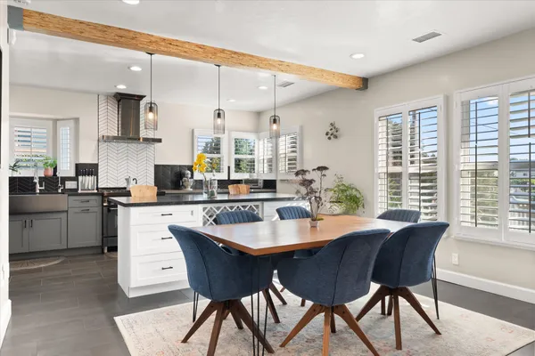 a kitchen with stainless steel appliances granite countertop a sink stove refrigerator and cabinets