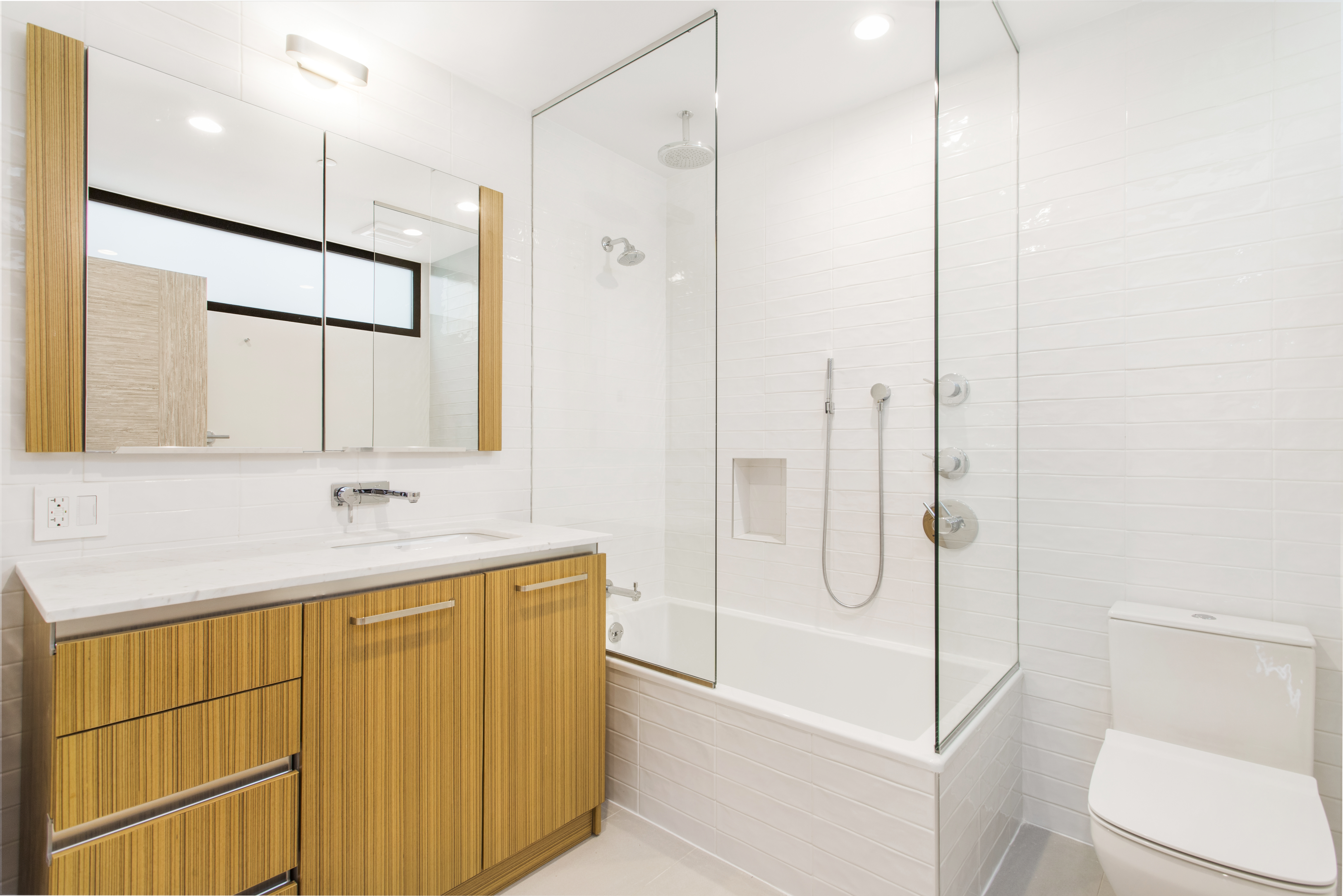 785 Hart Street, Unit THB Brooklyn, NY 11237 - Photo 13 of 15 a bathroom with a granite countertop sink a toilet and shower