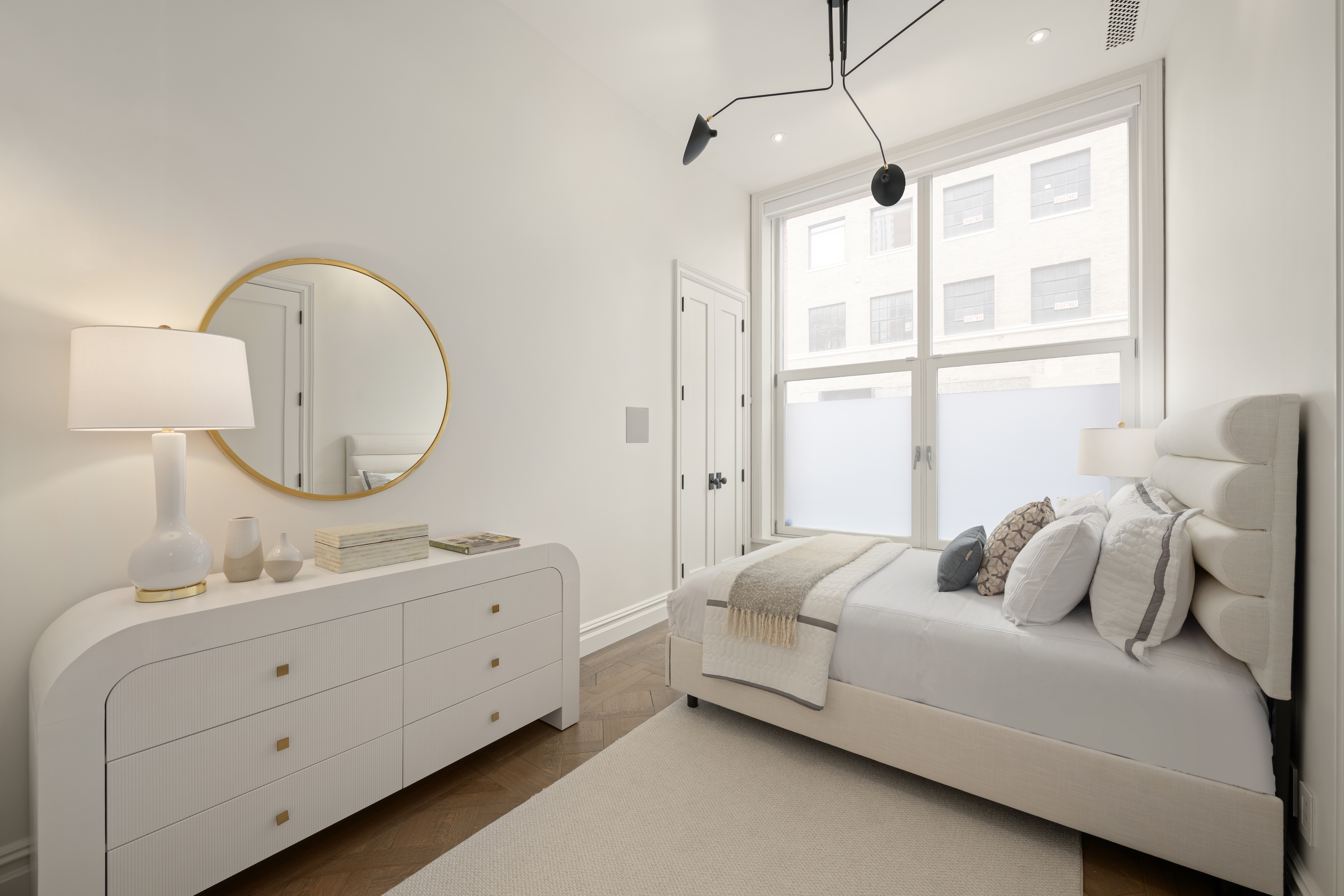 415 Washington Street, Unit 1B Manhattan, NY 10013 - Photo 11 of 16 a bedroom with bed and a mirror on the dresser