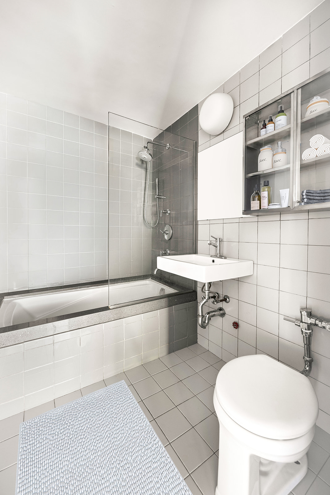 303 Beverley Road, Unit 3H Brooklyn, NY 11218 - Photo 8 of 11 a bathroom with a sink a toilet and shower