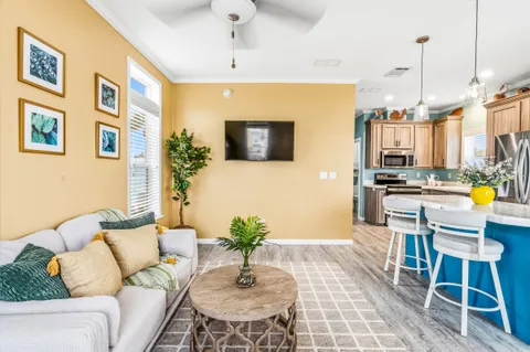 a kitchen with stainless steel appliances kitchen island granite countertop a table chairs and a refrigerator