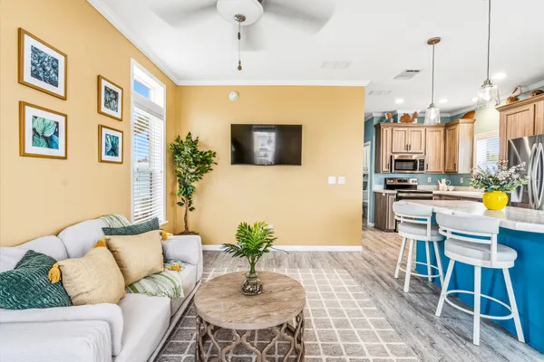 a kitchen with stainless steel appliances kitchen island granite countertop a table chairs and a refrigerator