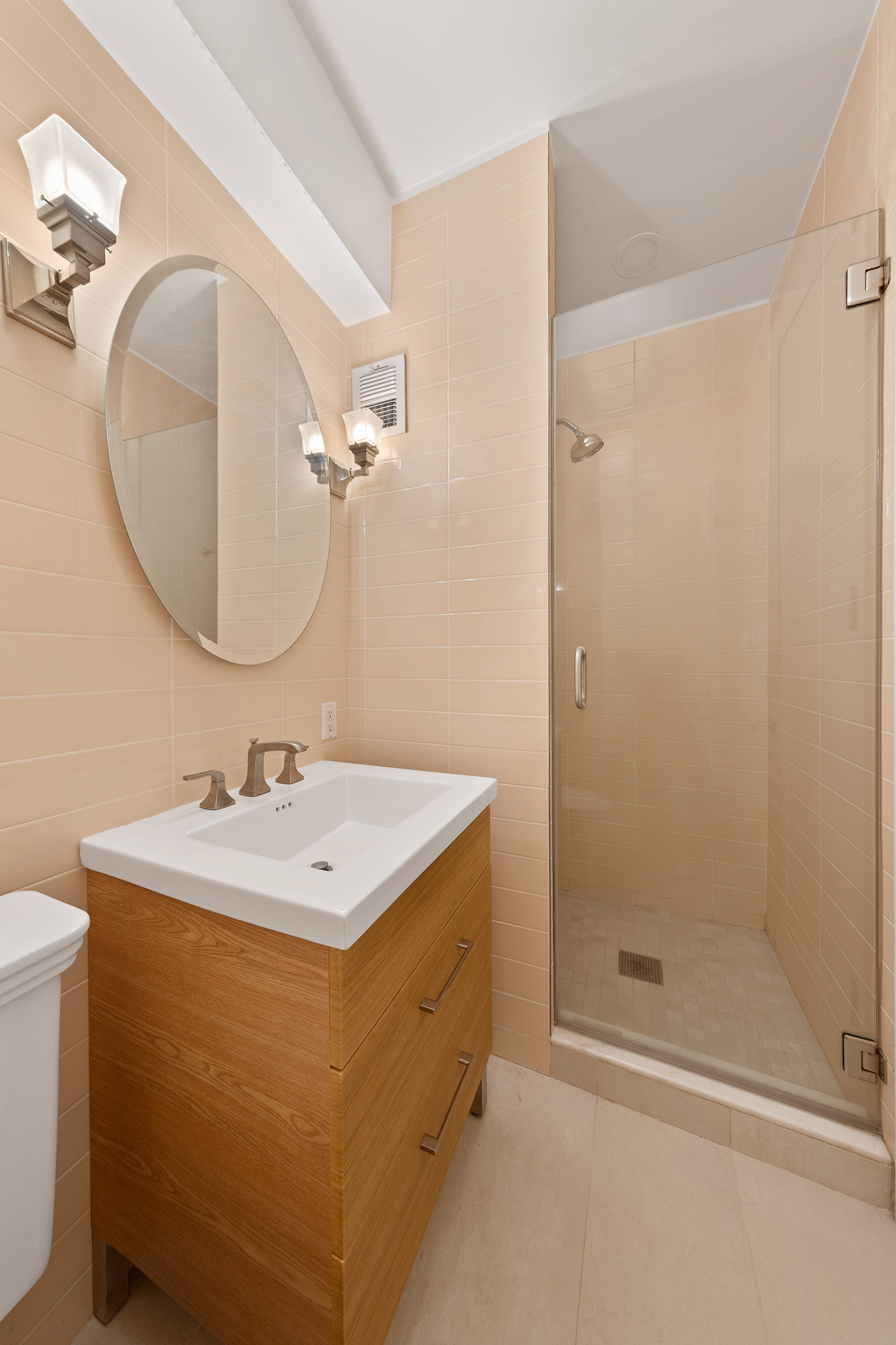 216 East 75th Street, Unit 3EAST Manhattan, NY 10021 - Photo 7 of 9 a bathroom with a sink a toilet and shower